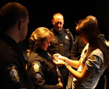 Police receiving pin as part of Forest City Times project